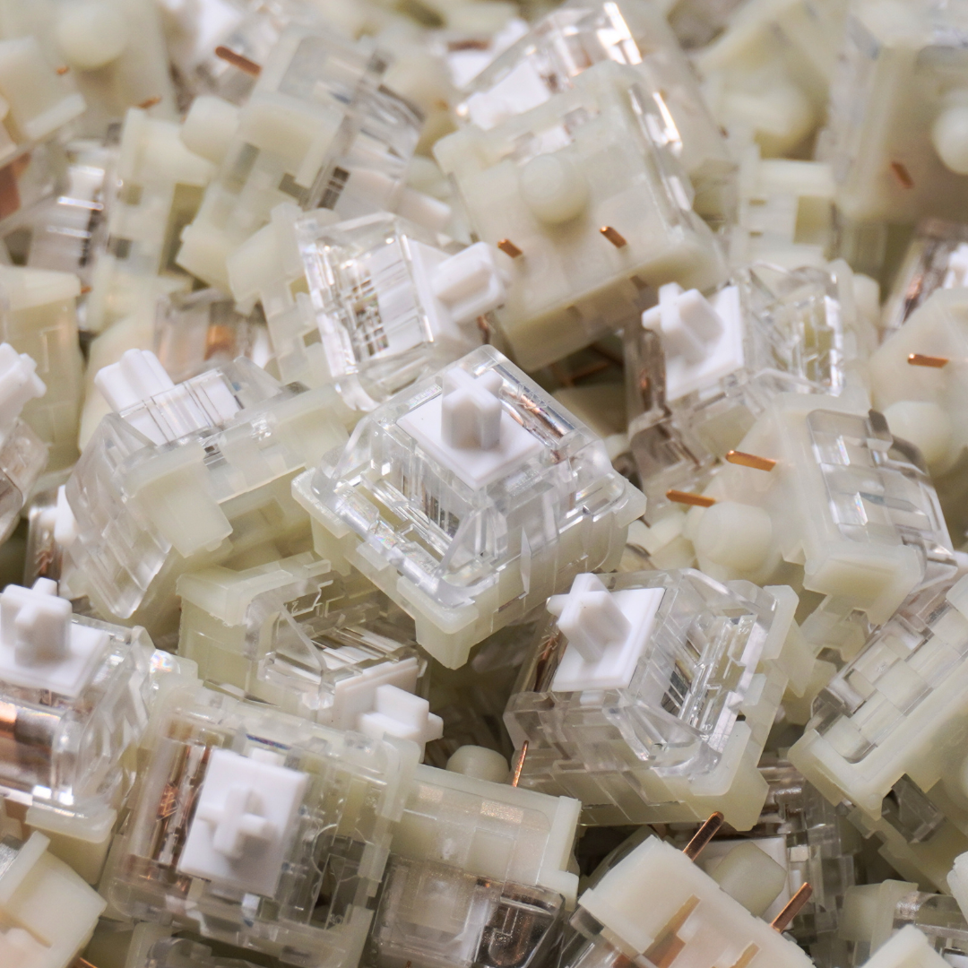 Photo of KTT Kang White V3 mechanical linear switches in a pile with one switch drawing the focus