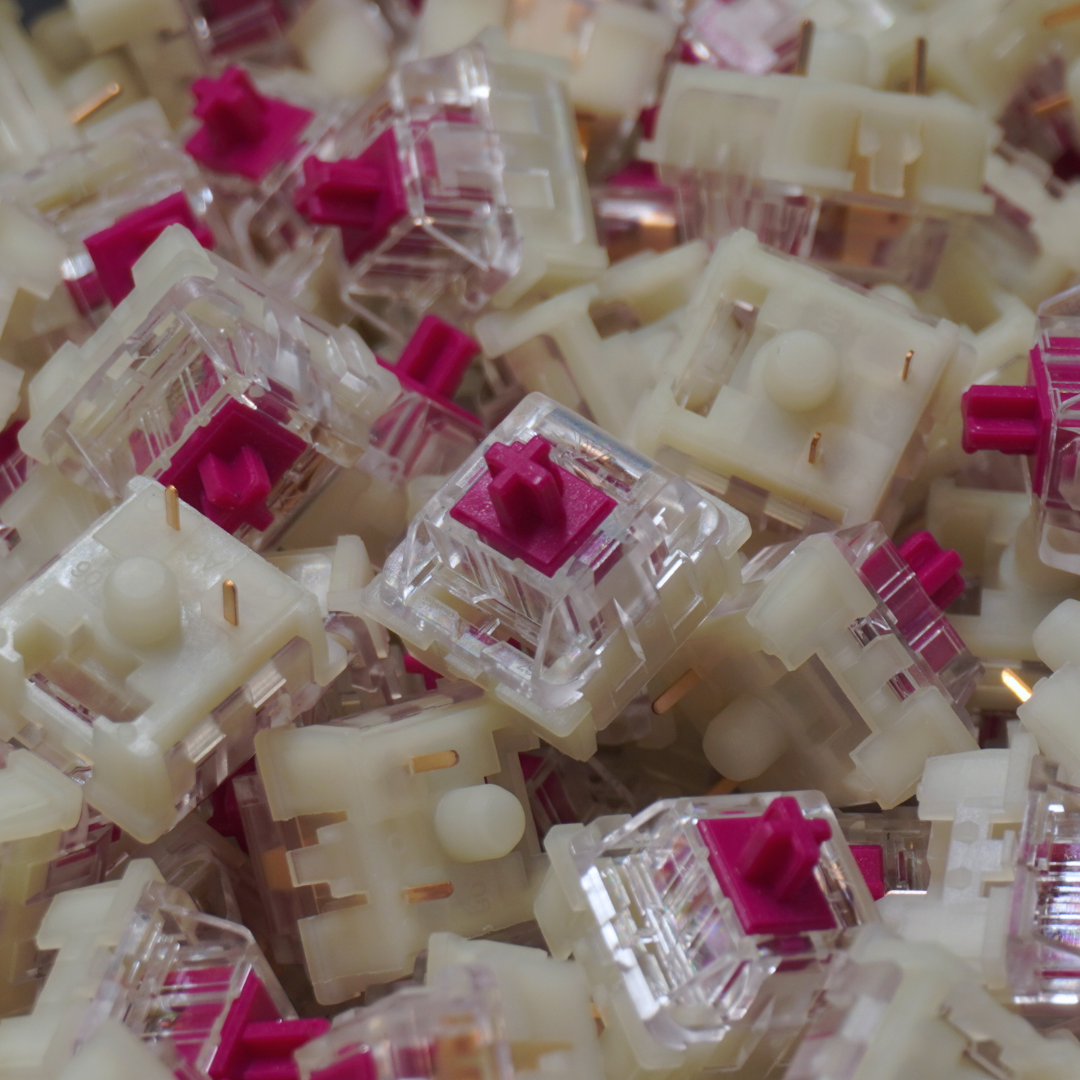 A photo of a pile of KTT Red Wine switches, with one switch drawing the focus