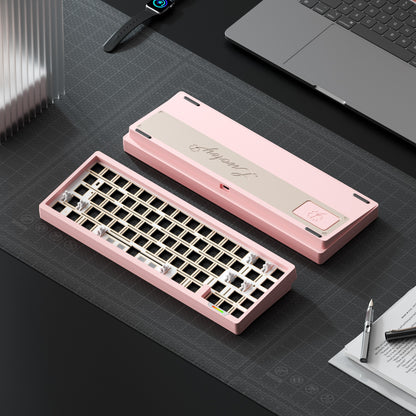 Pink mechanical keyboard on a desk with a laptop and stationery items.