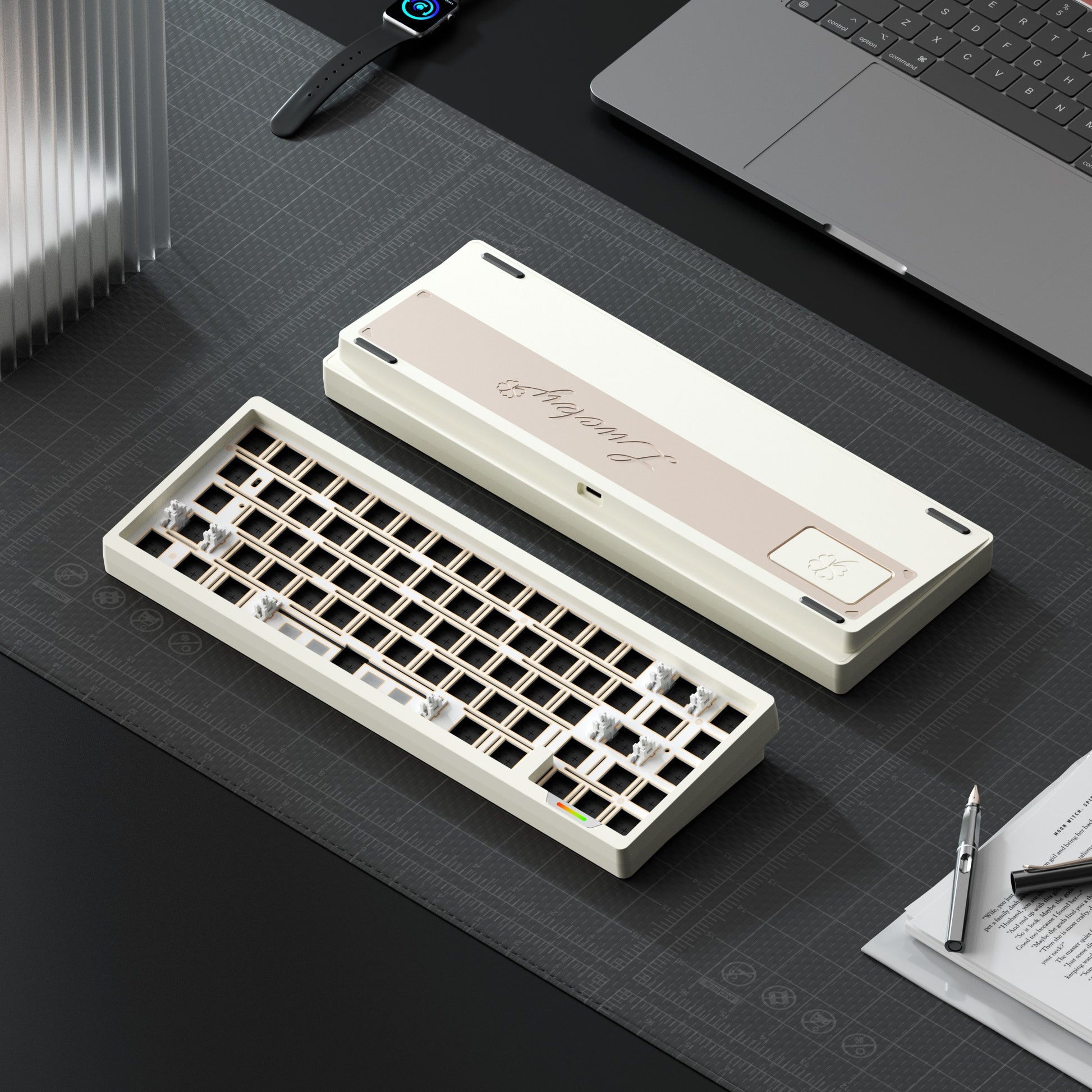 Mechanical keyboard on a desk with a laptop and stationery items