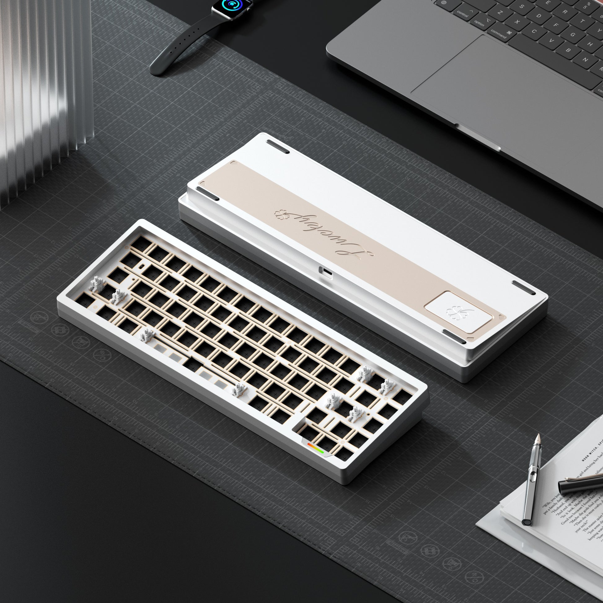 Mechanical keyboard on a desk with a laptop and stationery items