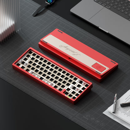 Red keyboard with a carrying case on a desk with a laptop and stationery items.