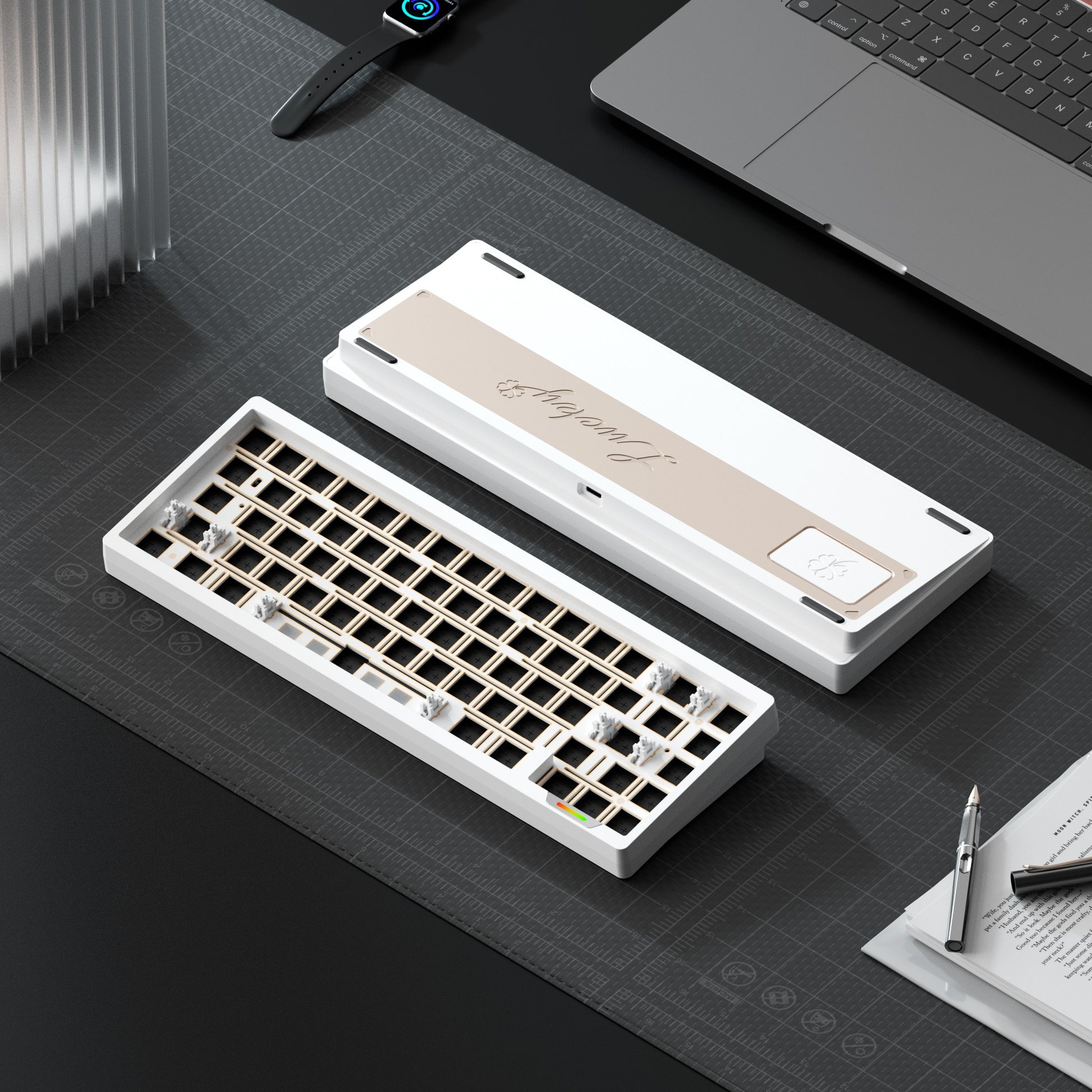 Mechanical keyboard on a desk with a laptop and stationery items.