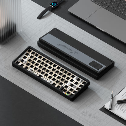 Mechanical keyboard components on a desk with laptop, notebook, and pen.