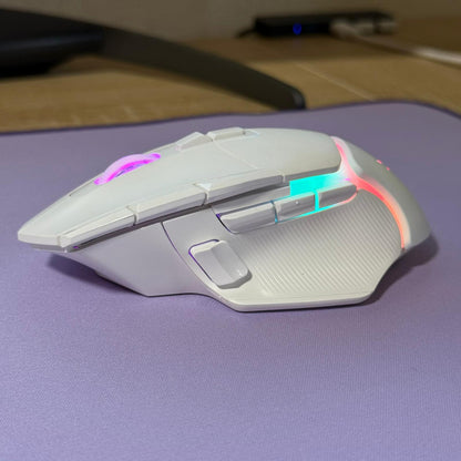 Gaming mouse with RGB lighting on a purple surface