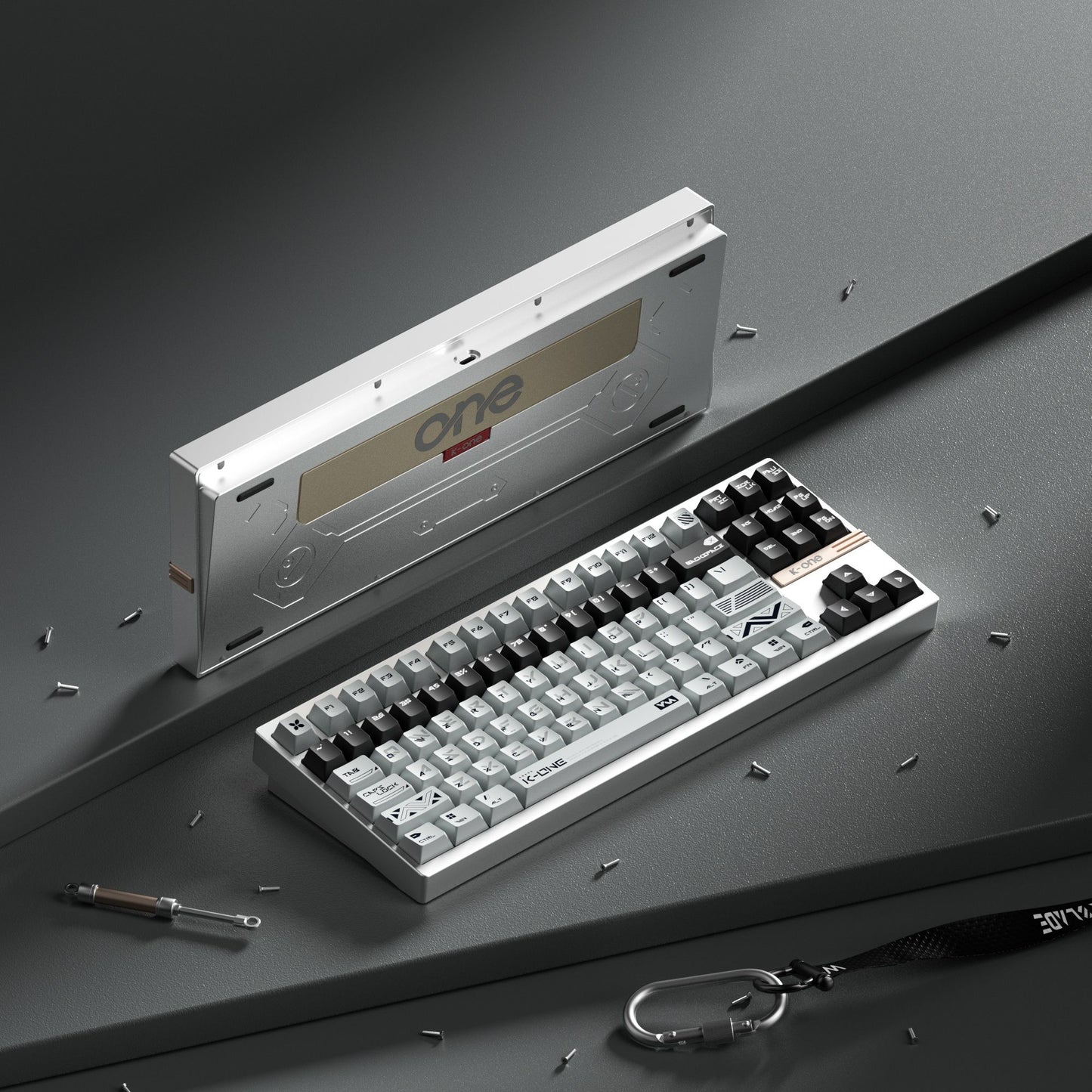 Mechanical keyboard with a tool and keychain on a gray surface