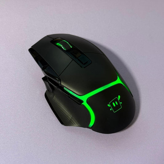 Black gaming mouse with green accents on a light gray background