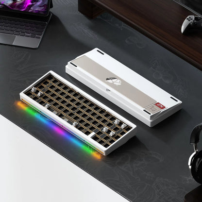 Mechanical keyboard with RGB lighting on a desk with a laptop and headphones.