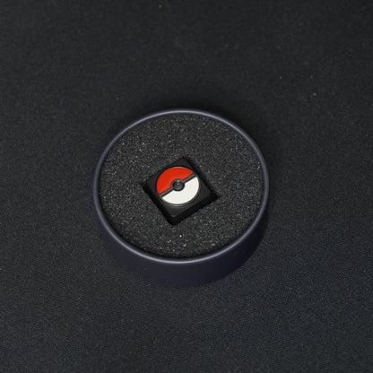 A detail photo of the PokeBall metal artisan anime keycap in its Packaging Tin