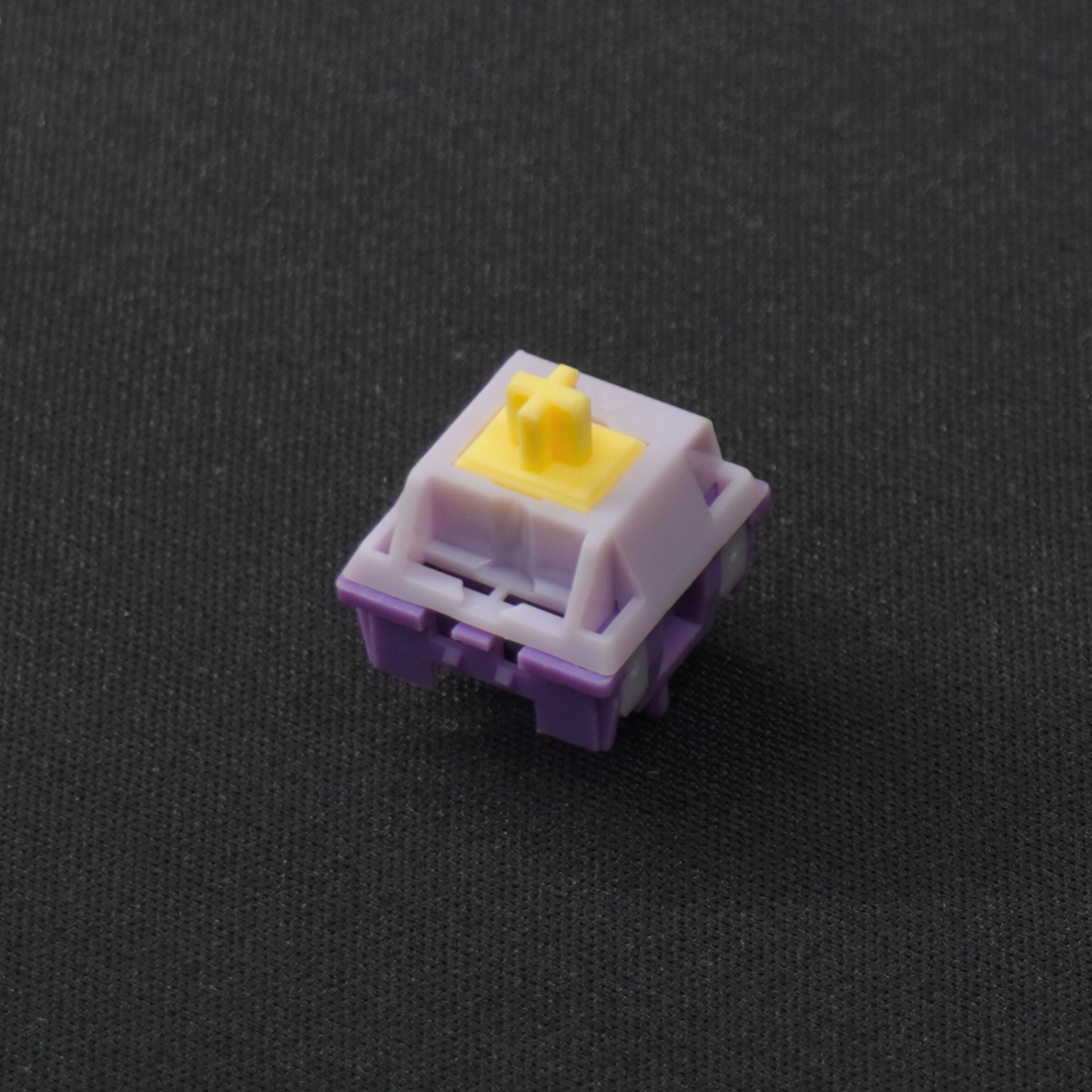 A photo of a single KTT Hyacinth linear mechanical switch on a 45 degree angle