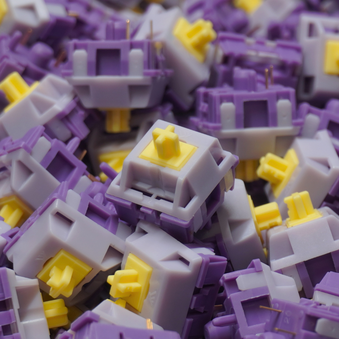 A photo of a pile of KTT Hyacinth linear mechanical switches with one main switch in focus