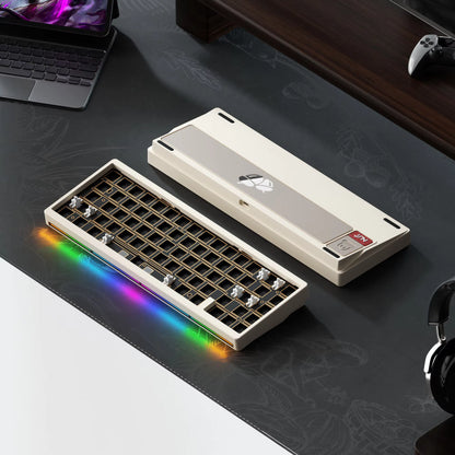 Mechanical keyboard with RGB lighting on a desk with a laptop and headphones.