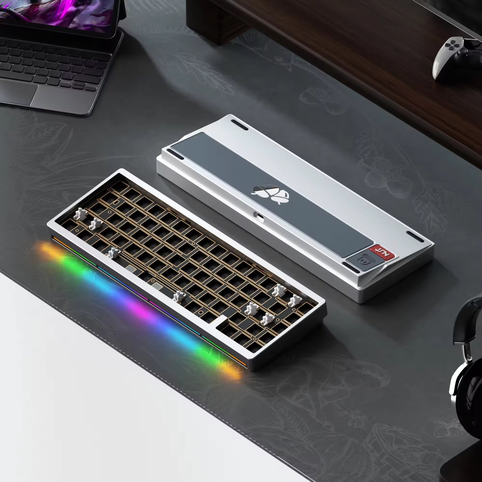 Modular keyboard with RGB lighting on a desk with laptop and headphones.